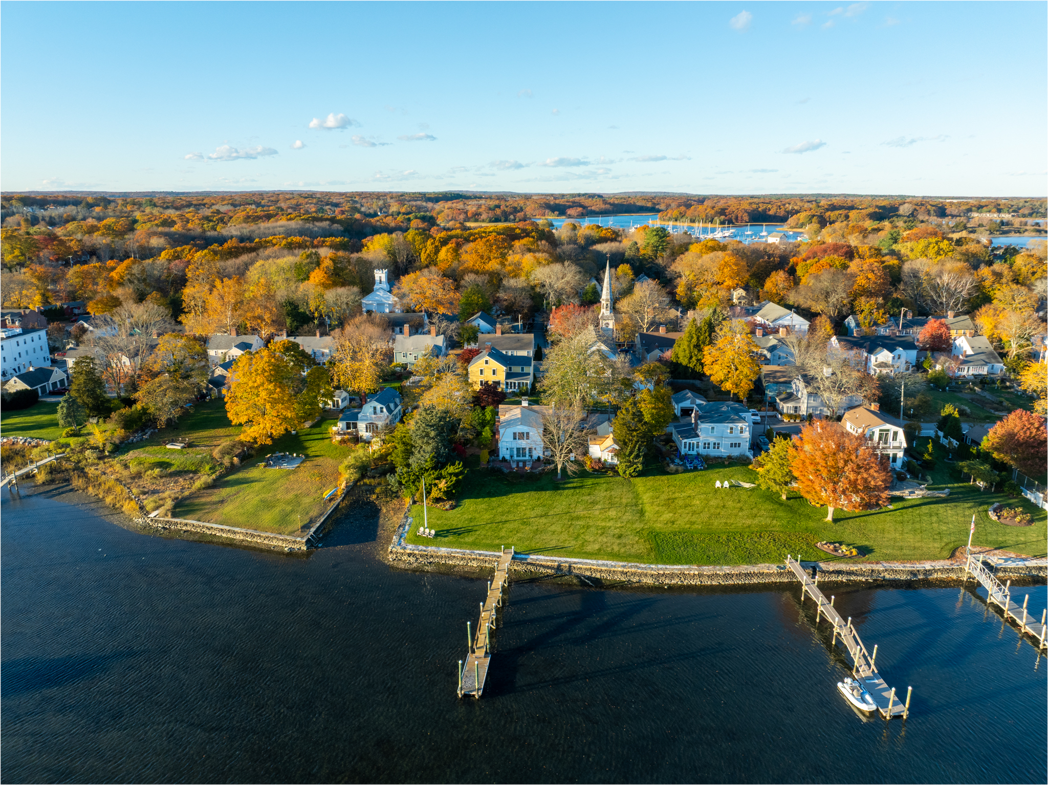 Drone photo of a Rhode Island coastal village with fall foliage