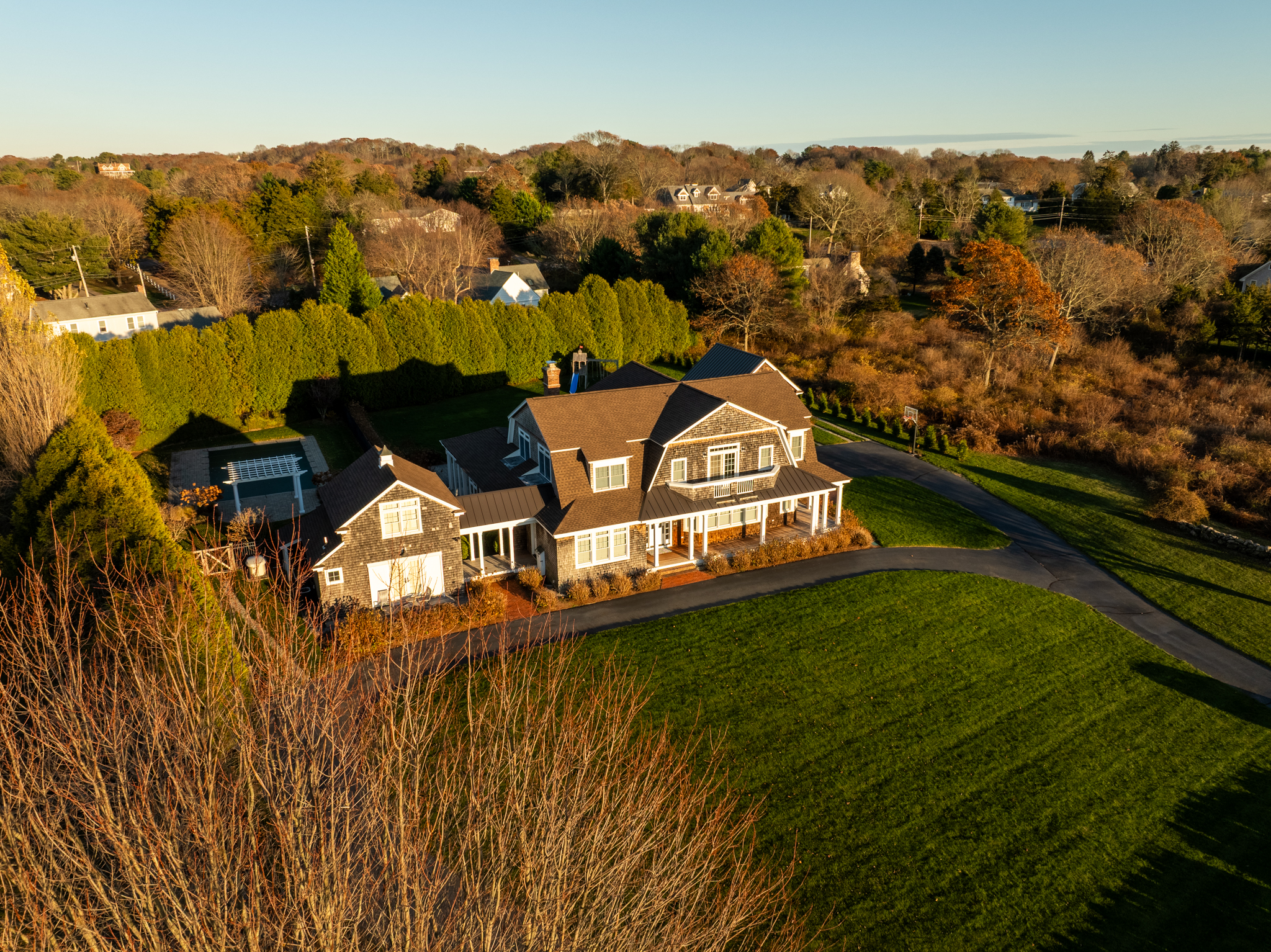 Drone photo of a large coastal estate with manicured lawn