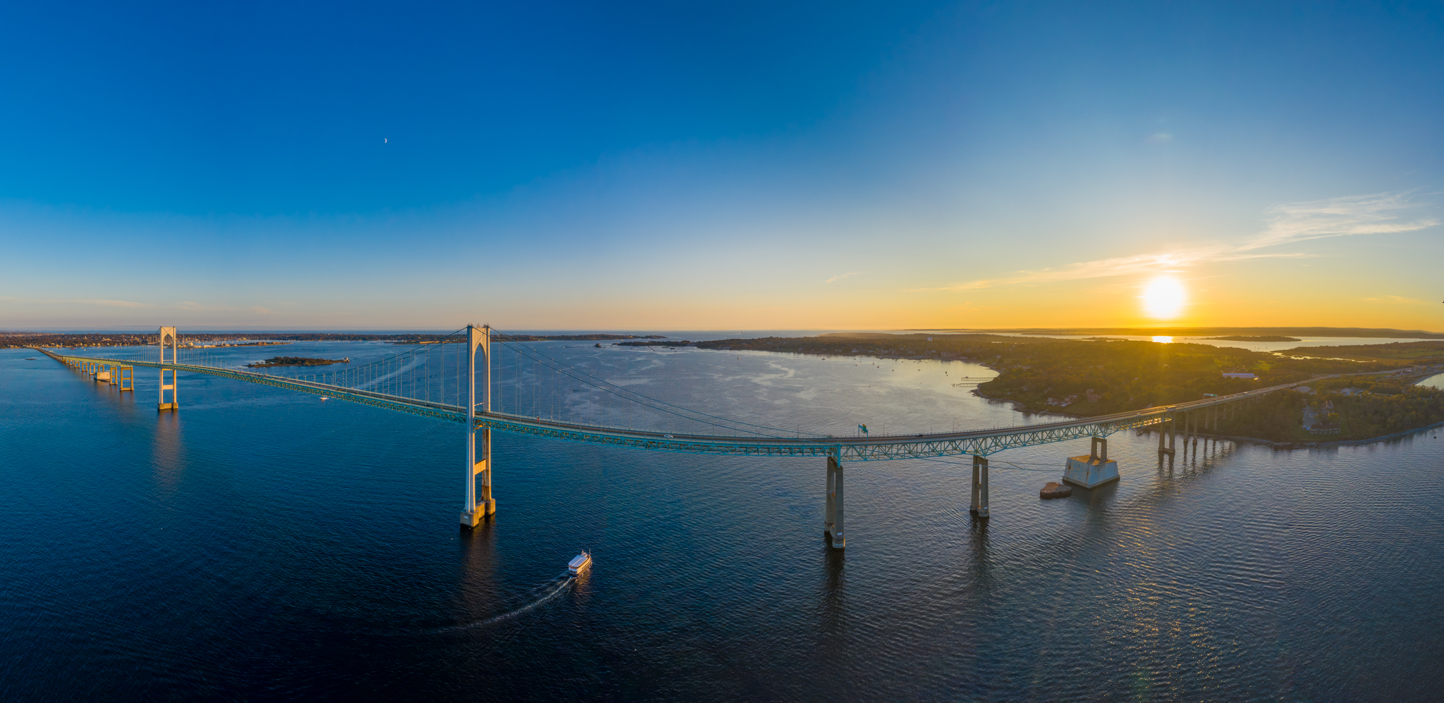 Drone shot of the Claiborne Pell Bridge at golden hour sunset over Narragansett Bay
