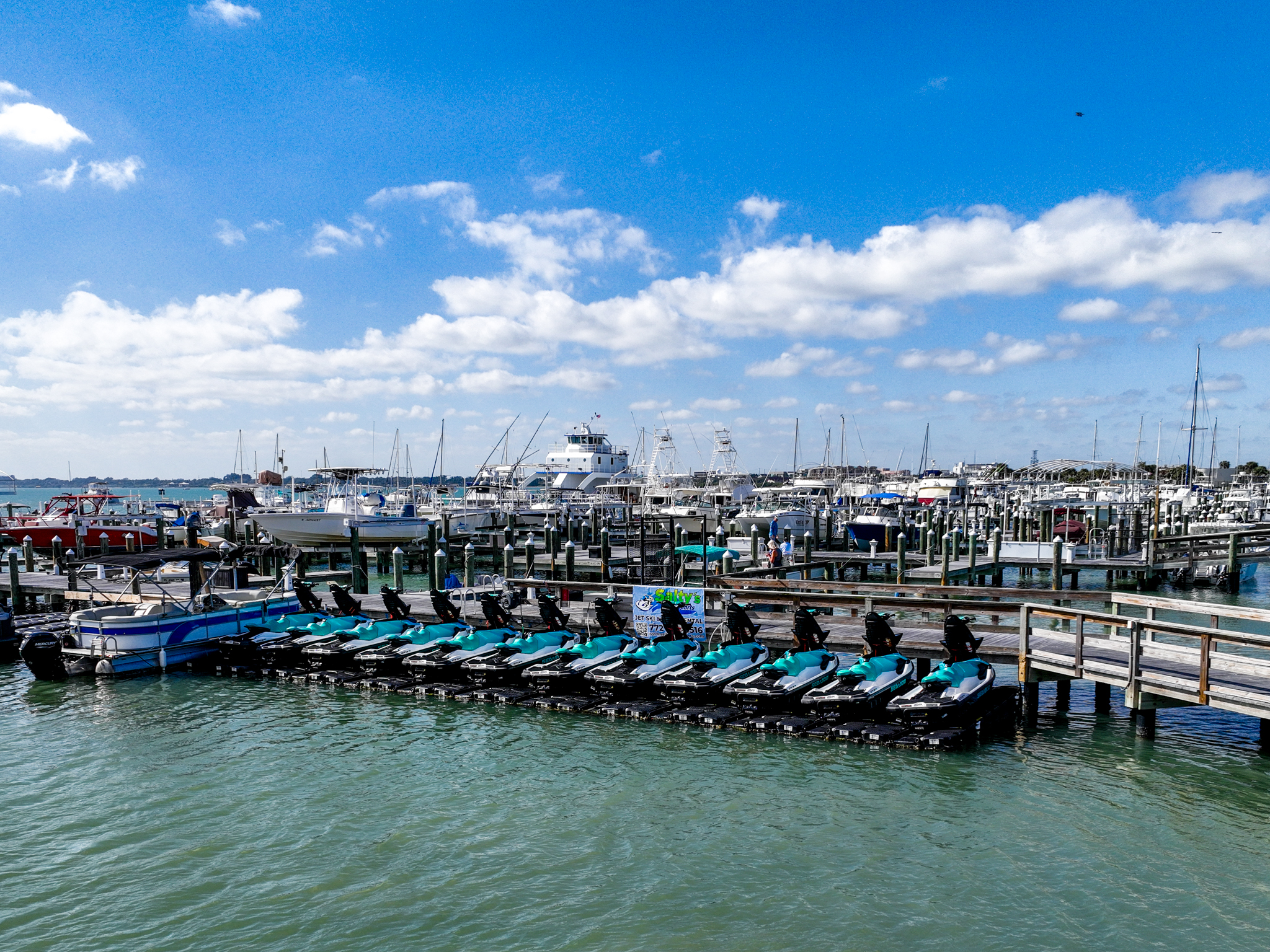 Photo of a jet ski rental fleet lined up at a marina dock
